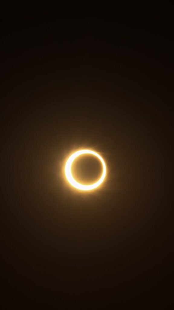 Beautiful annular solar eclipse over dark sky, creating a glowing ring effect.